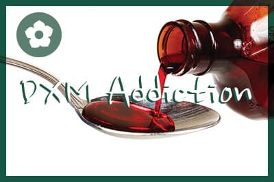 A bottle of cold medicine poured into a spoon