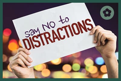 Say No To Distractions placard with night lights on background
